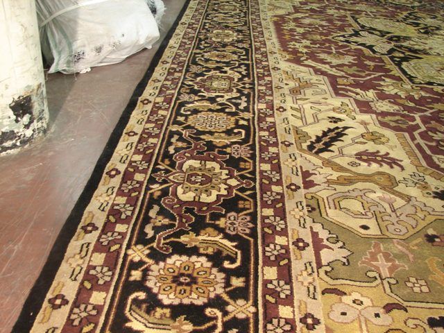   wine surrounded with gold, green black make the rug very decorative